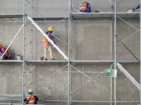Group of construction worker plastering cement concrete water tank in construction area